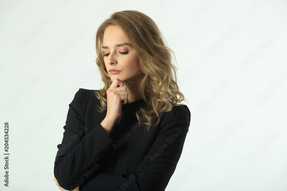 a strict beautiful young girl in a black jacket on a white background with a pensive look a strict beautiful young girl in a black jacket on a white background with a pensive look