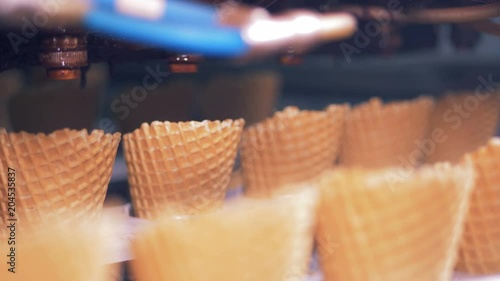 Close up of rows of wafer cones consequently moving