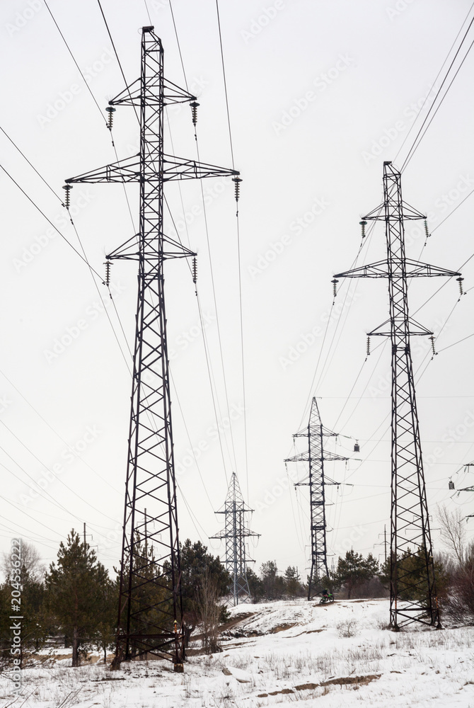 Electricity pylons and power lines in the winter day Electricity pylons and power lines in the winter day
