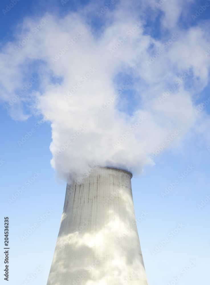 Cooling tower with water vapor over it Cooling tower with water vapor over it
