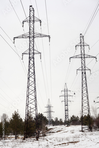 Electricity pylons and power lines in the winter day