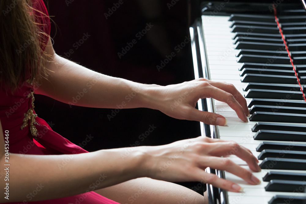 Close-up of woman hands playing piano - selective focus Photos | Adobe Stock