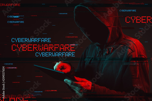 Cyberwarfare concept with faceless hooded male person