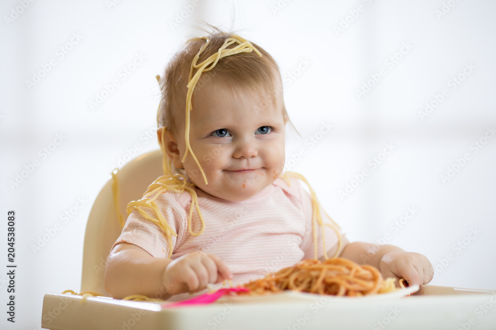 Little baby girl eating her lunch and making a mess Little baby girl eating her lunch and making a mess