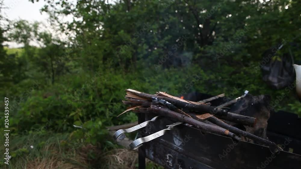 Kettle sitting on a camping open fire firepit Kettle sitting on a camping open fire firepit