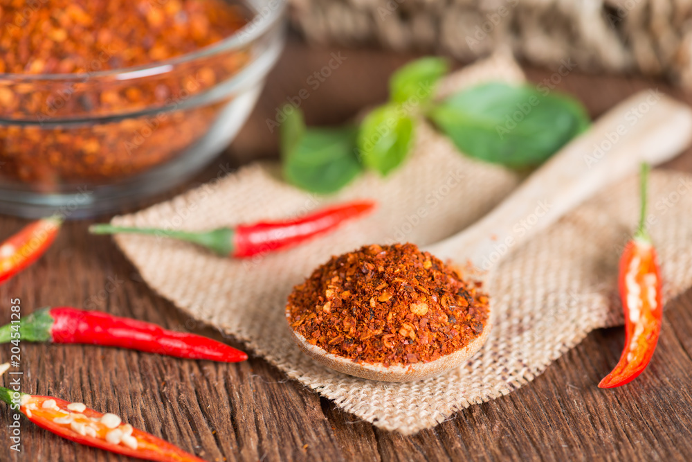 Chili powder in spoon and red chili pepper. Chili powder in spoon and red chili pepper.