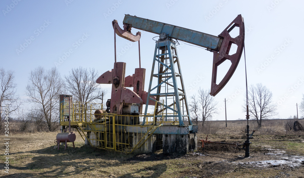 Oil pump machine over the blue sky Oil pump machine over the blue sky