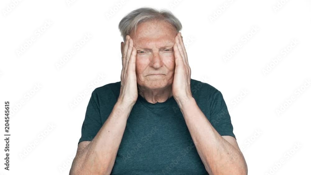 Portrait of sick or tired old aged man 80s having gray hair in basic t-shirt rubbing temples because of headache slow motion, isolated over white background Portrait of sick or tired old aged man 80s having gray hair in basic t-shirt rubbing temples because of headache slow motion, isolated over white background