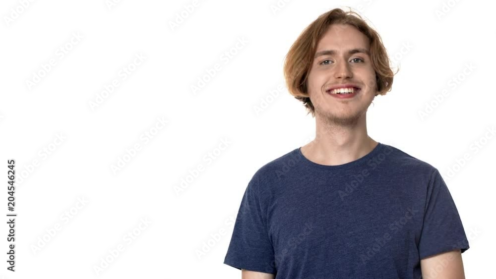 Portrait of satisfied young guy in casual t-shirt nodding in acceptance and pointing finger aside on copy space, isolated over white background. Concept of emotions Portrait of satisfied young guy in casual t-shirt nodding in acceptance and pointing finger aside on copy space, isolated over white background. Concept of emotions