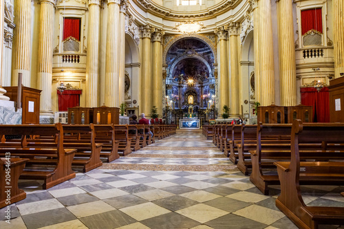 interior of a church with people who pray and approach God