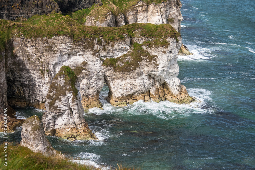 Stunning limestone cliffs at Magheracross viewpoint. White Rocks on Causeway Coastal Route, Portrush, Northern Ireland Stunning limestone cliffs at Magheracross viewpoint. White Rocks on Causeway Coastal Route, Portrush, Northern Ireland
