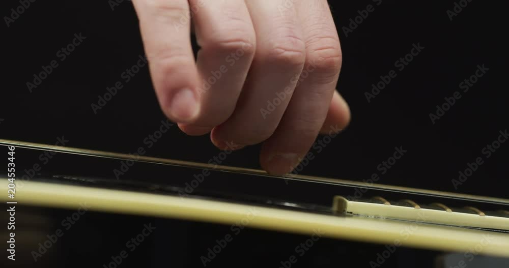 Extreme close up of fingers strumming the strings Extreme close up of fingers strumming the strings