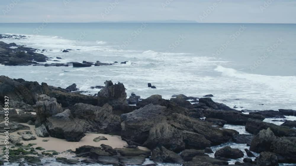 slow motion sea waves on rocks