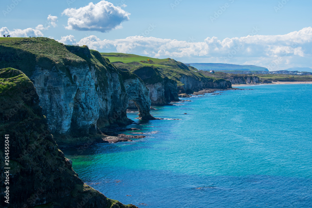 landscape over cliffs and coast of ocean in northern ireland. beautiful view of nature. clear sky and sunny day 