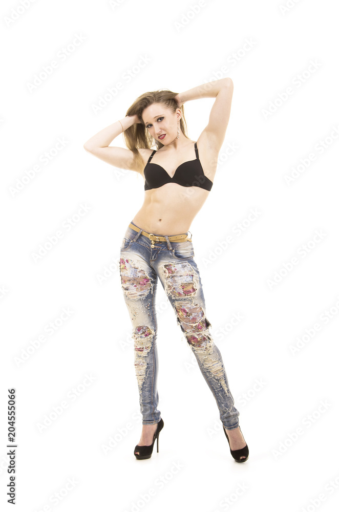 Girl with long hair, jeans, posing in the Studio. Girl with long hair, jeans, posing in the Studio.
