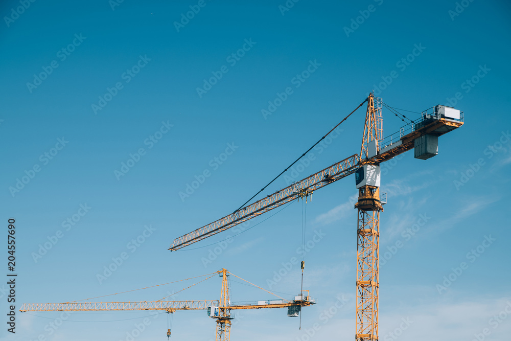 construction cranes on blue sky background. Russia, Moscow