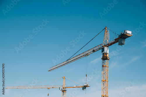 construction cranes on blue sky background. Russia, Moscow