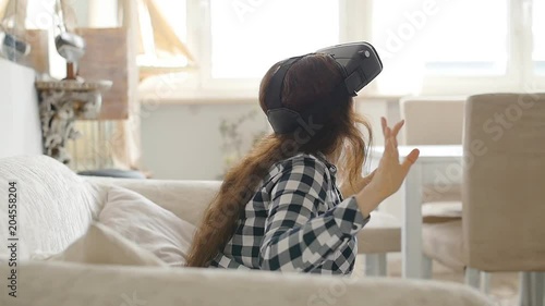 Young woman using Virtual Reality headset photo