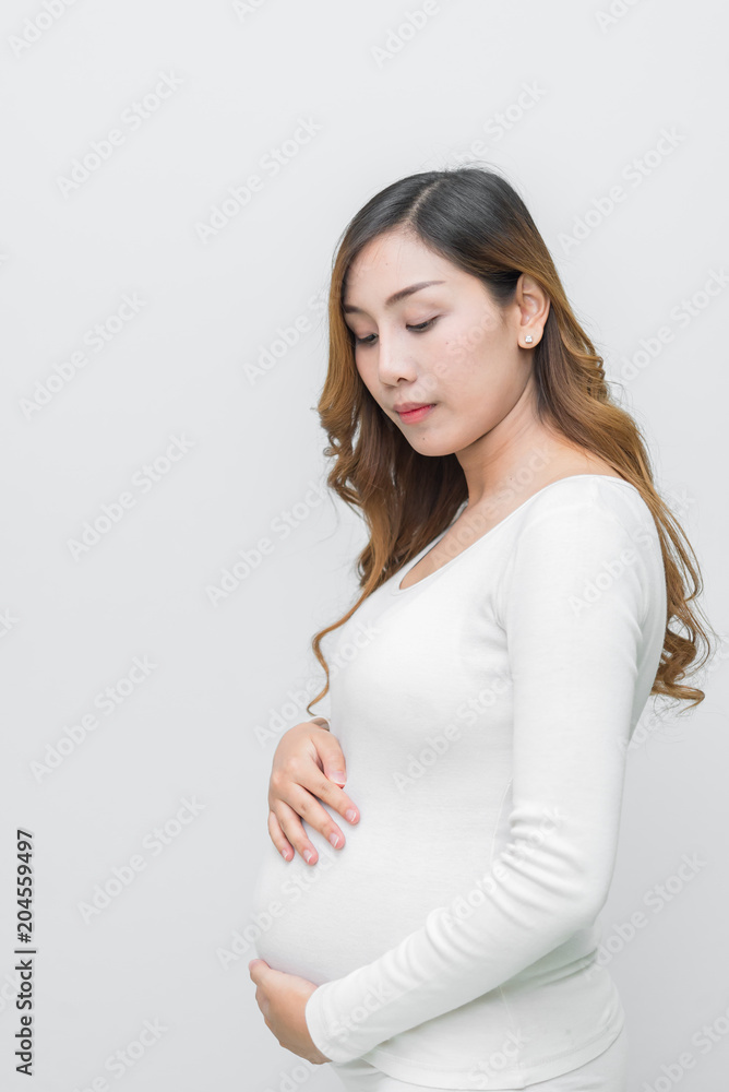 A pregnant woman in white dress stand pose for take a picture on white background A pregnant woman in white dress stand pose for take a picture on white background