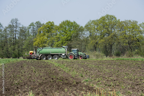 The manure is introduced into the field with a two-slice injection. Gütersloh, North Rhine-Westphalia, Germany, Europe.
