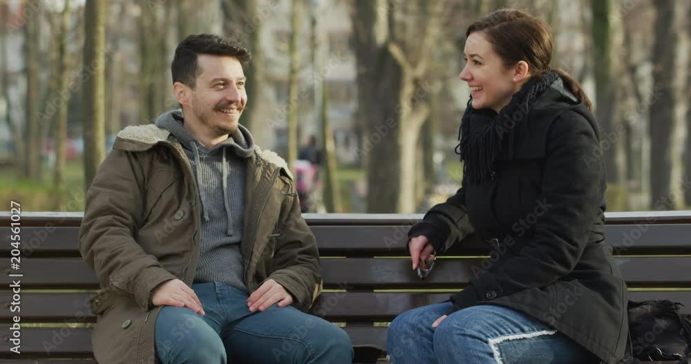 Man and woman sitting on a bench Man and woman sitting on a bench