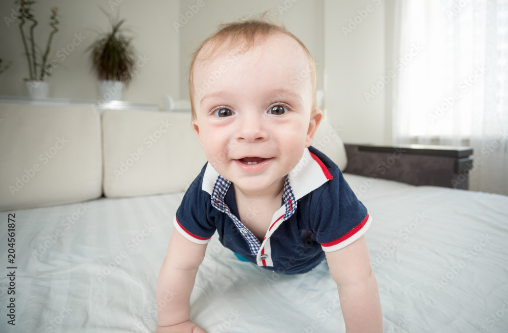 Wide angle closeup portrait of cute smiling baby boy looking in camera Wide angle closeup portrait of cute smiling baby boy looking in camera