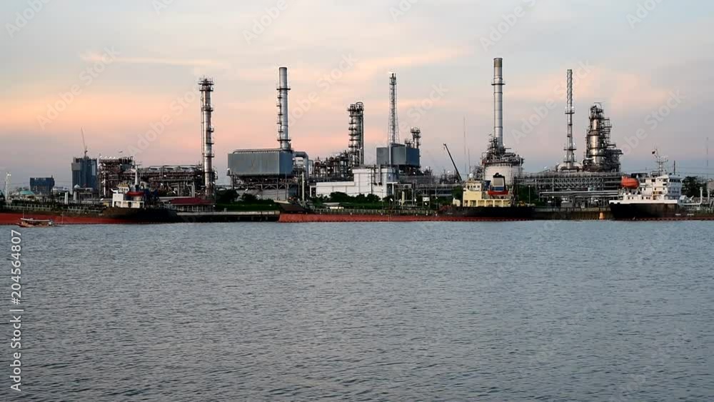 Oil refinery at the river in sunset time Oil refinery at the river in sunset time