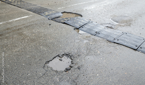 Damaged speed bump on the road