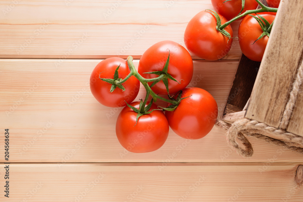 Close-up of fresh, ripe tomatoes on wooden background. Top view. Close-up of fresh, ripe tomatoes on wooden background. Top view.