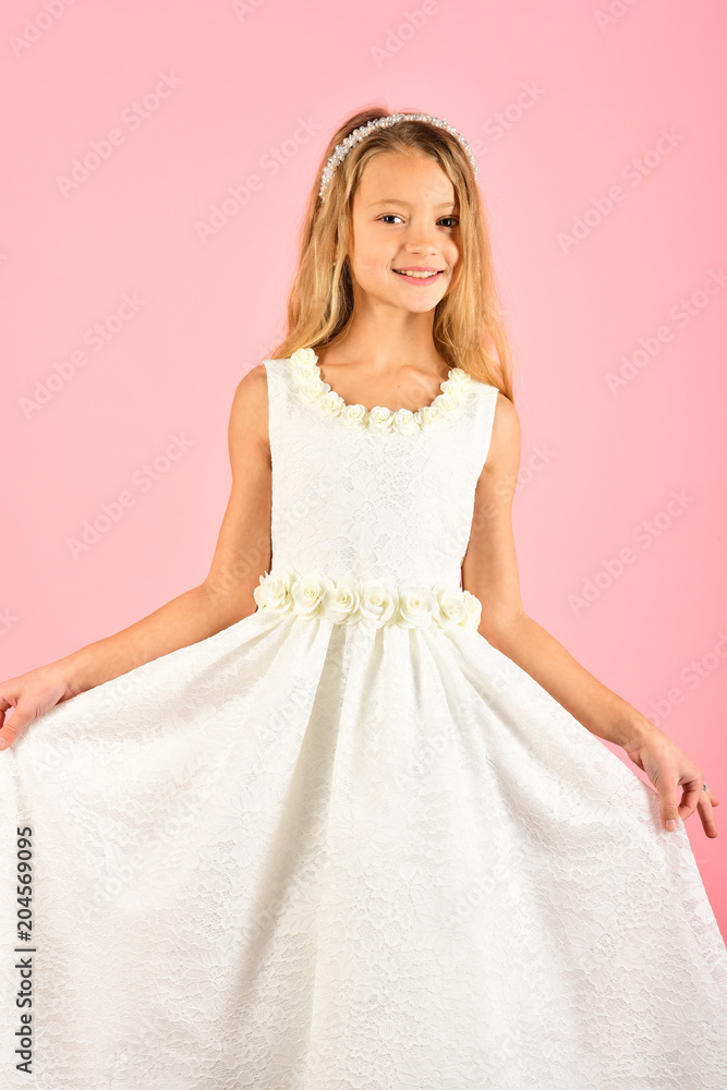 Fashion and beauty, little princess. Fashion model on pink background, beauty. Look, hairdresser, makeup. Child girl in stylish glamour dress, elegance. Little girl in fashionable dress, prom.