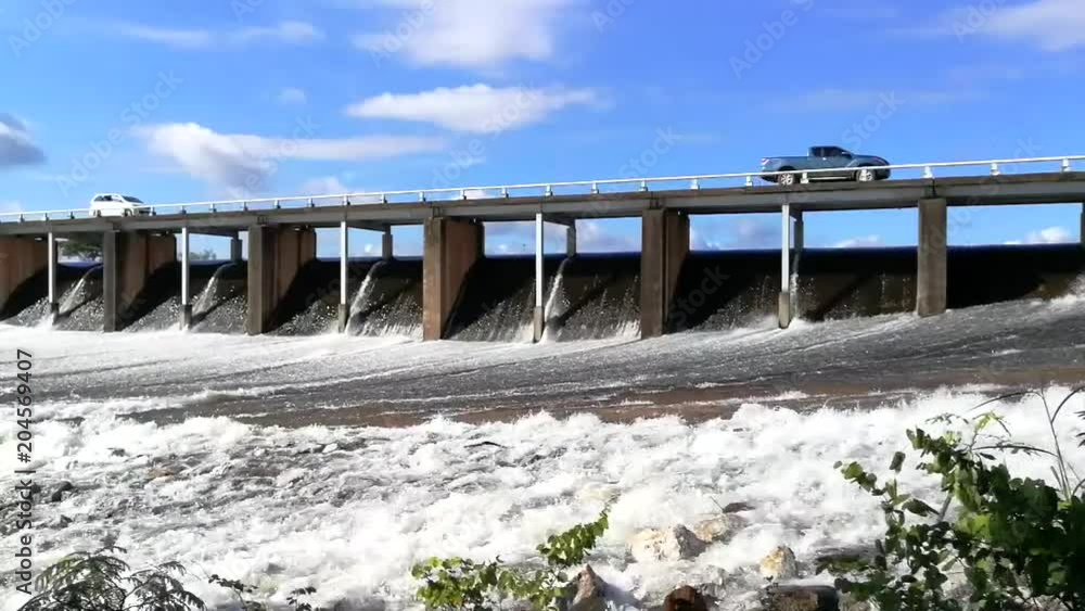 River Water Flowing Quickly Over an Overflow Dam River Water Flowing Quickly Over an Overflow Dam