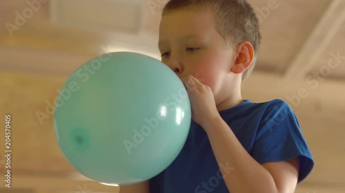 boy inflate a balloon
