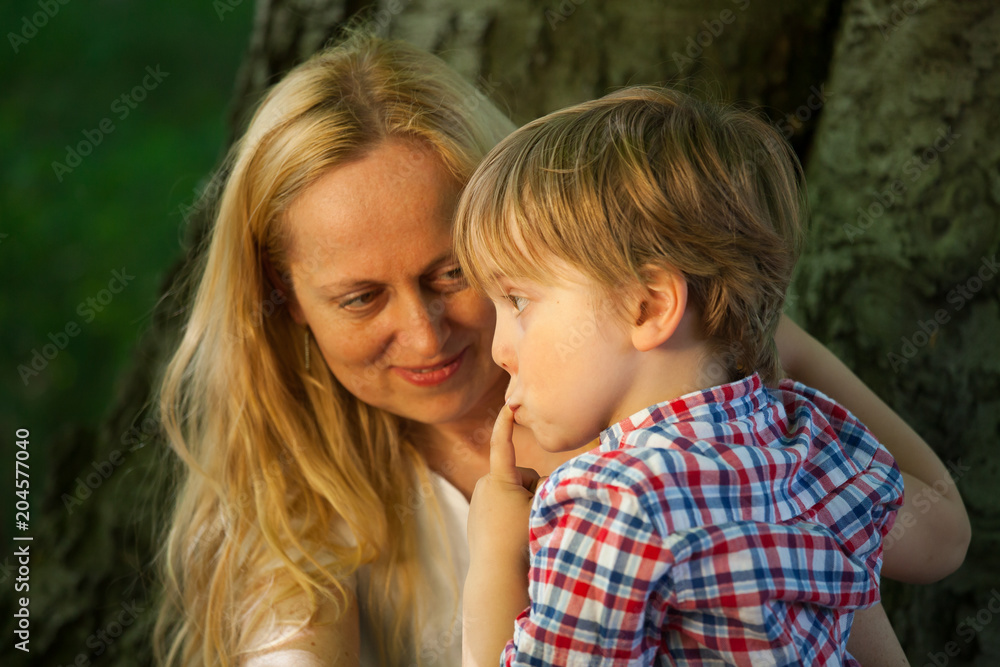 Mother looks at her son who looks like he has done some mischief