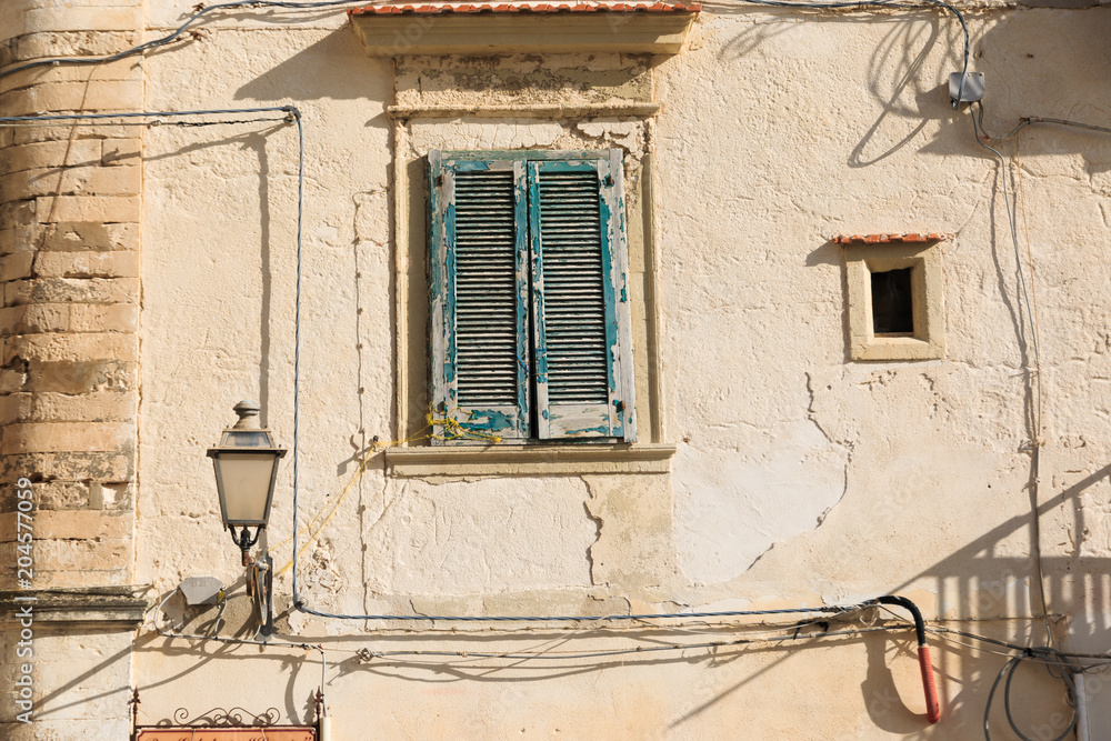 Italy, Foggia, Apulia, SE Italy, Gargano National Park, old - town Vieste. Shuttered window with street light. Italy, Foggia, Apulia, SE Italy, Gargano National Park, old - town Vieste. Shuttered window with street light.