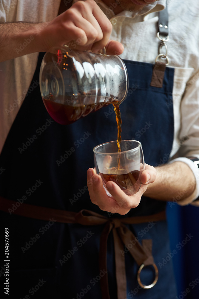 Barista making coffee, bartender or coffee maker preparing coffee drink
