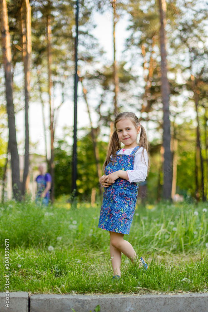 little brother and the sister sit on a glade with fluffy white dandelions little brother and the sister sit on a glade with fluffy white dandelions