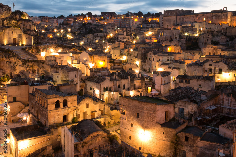 Italy, Southern Italy, Region of Basilicata, Province of Matera, Matera. Small cobblestone streets and stairways of the town. Night time overview.