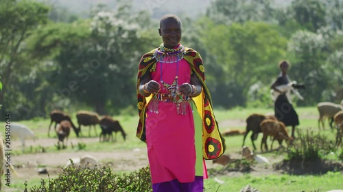 Maasai woman smiling and dancing photo