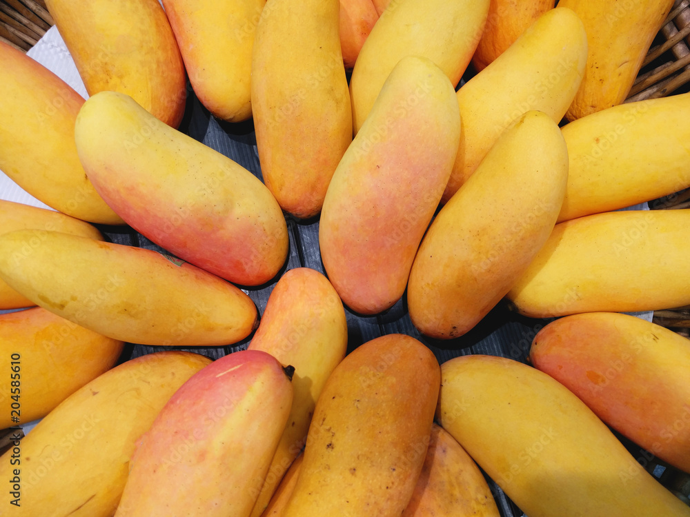Fresh Golden mangoes on shelf in the supermarket use for background.