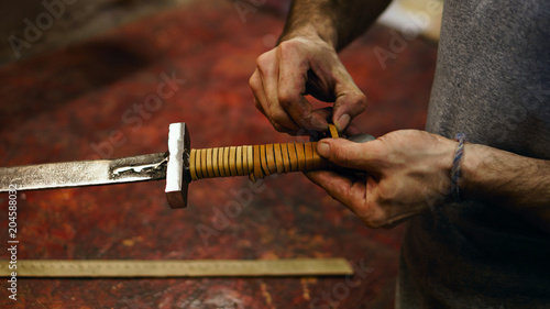 Photography Smith makes leather winding of sword