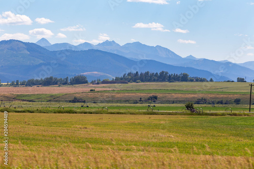 Mountains, hills, and fields in rural Montana.