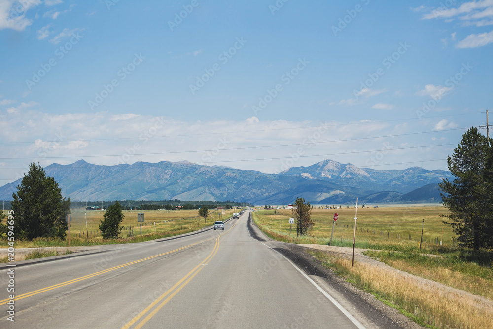 Highway in remote Montana landscape. Summer day setting.
