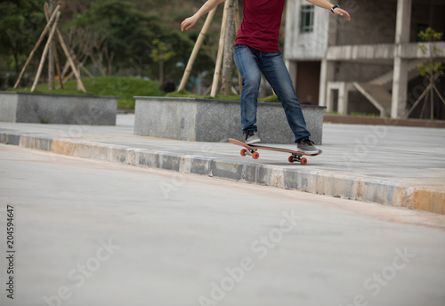 Skateboarder riding skateboard going down the step
