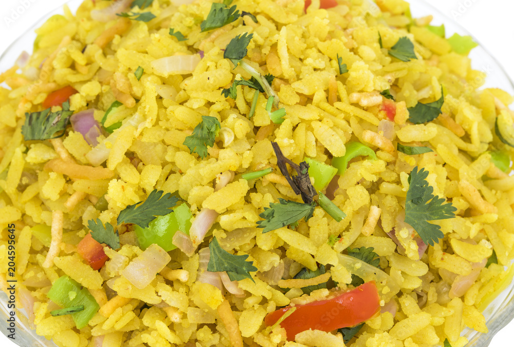 Indian Breakfast Dish Poha Also Know as Pohe or Aalu poha made up of Beaten Rice or Flattened Rice. The rice flakes are lightly fried in oil with mustard, chilly, onion, curry leaves and turmeric Indian Breakfast Dish Poha Also Know as Pohe or Aalu poha made up of Beaten Rice or Flattened Rice. The rice flakes are lightly fried in oil with mustard, chilly, onion, curry leaves and turmeric