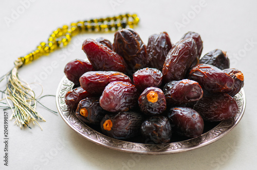 Close up of medjoul - dried dates or kurma in a vintage plate. photo