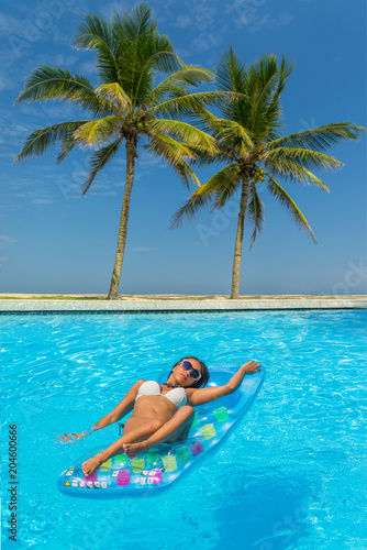 Woman at the swimming pool at the tropical resort