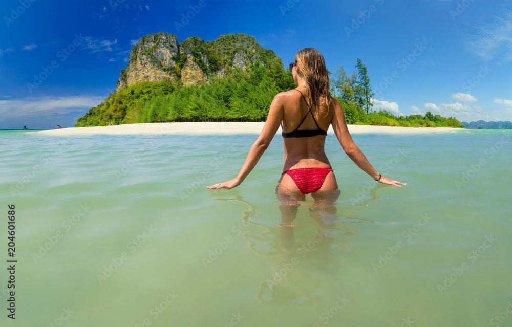 Attractive woman with perfect body standing up in sea,