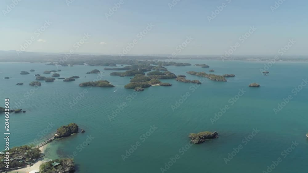 Aerial view of Small islands with beaches and lagoons in Hundred Islands National Park, Pangasinan, Philippines. Famous tourist attraction, Alaminos.