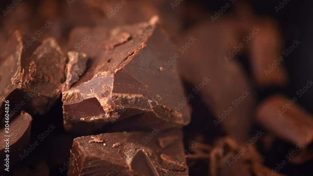 Chocolate. Chunks of sweet dark chocolate rotated closeup. Dessert ingredient. Confectionery. Slow motion 4K UHD video 3840X2160 Chocolate. Chunks of sweet dark chocolate rotated closeup. Dessert ingredient. Confectionery. Slow motion 4K UHD video 3840X2160