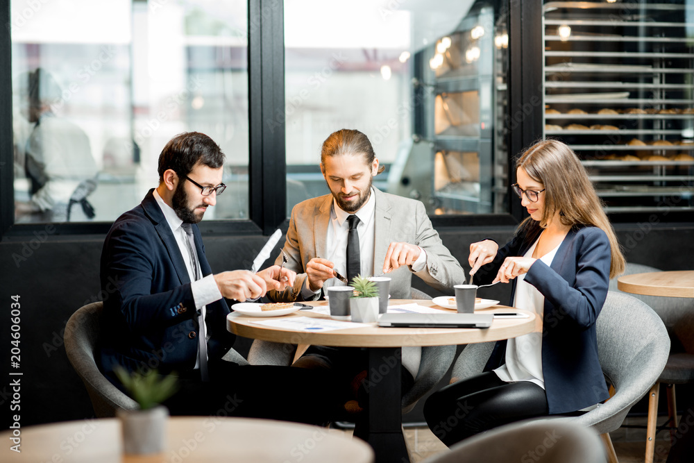 Business people eating in the cafe Business people eating in the cafe